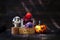 Wooden doctor ghost with colorful yarn spider in treasure box and halloween pumpkin