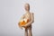 Wooden doll holding blocks of cheddar cheeses in arms