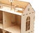 Wooden dollhouse with little furniture on a white background