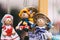 Wooden dolls dressed in different outfits. handmade wooden dolls hanging as a display. decorative dolls
