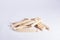 Wooden dolly clothes pegs on white background