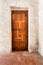 Wooden Door against Whitewashed Plaster Wall