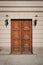 Wooden door building entrance on street with lanterns on wall