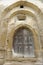 Wooden door in carved, stone wall, Copsa Mare, Romania