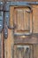 Wooden door with decorative rusted metal hinges