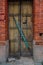 The wooden door of dilapidated building in a city