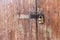 Wooden door with lock. Lock on an old wooden gate. Old padlock on closed doors.