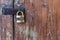 Wooden door with lock. Lock on an old wooden gate. Old padlock on closed doors.