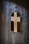 Wooden door with a metal crucifix of Jesus Christ.