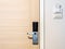 Wooden door with modern handle equipment and key card socket at the wall