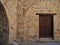 Wooden door in an old ancient building, old town, Mediterranean style.