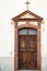 Wooden door of an old church. Vintage architecture of the rear entrance. Old church in a town