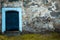 Wooden door in old stony wall