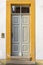 Wooden door with ornaments and ornaments and skylight of a restored half-timbered house with brushed sandstone frame