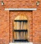 Wooden door on red brick wall background