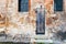 Wooden door in shabby brick wall