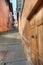 Wooden door and small paved street in Saluzzo.