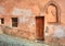 Wooden door and small paved street in Saluzzo.