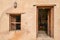 Wooden door and window leading into a room in medieval arabian fortress. Castle of Nakhal, Oman. Islamic architecture