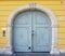 A wooden door on a yellow wall