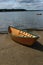 Wooden dory on the beach at low tide.