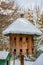 Wooden Dovecote with a roof cowered by snow