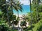 Wooden down way stairs to the beach, with palms around. Naithon beach, Phuket, Thailand