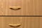 Wooden drawers with graceful slim pull handles. Furniture anteroom