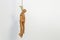 A wooden drawing mannequin hanging from a rope I