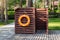 Wooden dressing changing room with orange lifebuoy at recreation area near pond, pool or lake at forest eco-frinedly resort. Cabin