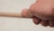 Wooden drumstick in hand. Concept. Close-up of hand holding drumstick in its hand and making beats. Professional
