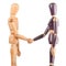 Wooden dummies shaking hands