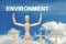 Wooden dummy puppet on sky background with word ENVIRONMENT