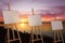 Wooden easels with blank canvases near river at sunset