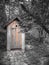 Wooden ecological composting toilet on countryside with a heart shape in the door