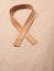 Wooden edge veneer curl on a natural paper,symbol for Liver Cancer awareness, World Cancer Day
