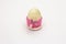 Wooden egg in pink crocheted stand isolated on white background. Easter zero waste