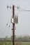 Wooden electricity pole with wires, insulators and transformer