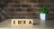 Wooden elements with letter on wooden table spelling word idea