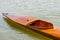 Wooden empty kayak on rowing canal close-up