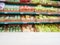Wooden empty table in front of blurred supermarket vegetables shelf