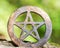 Wooden encircled pentagram symbol on fibrous tree bark. Five elements: Earth, Water, Air, Fire, Spirit.