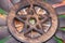 Wooden encircled Pentagram symbol with Unakite stone in the middle of a circle made of colorful parrot feathers. Five elements