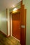 Wooden entrance door of residential apartment with light source