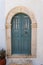 Wooden entrance in marble frame, on aegean island of Tinos, Greece.