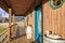 Wooden entrance porch with glass stained front door.