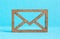 Wooden envelope icon on blue background