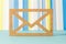 Wooden envelope icon on blue striped background