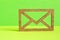 Wooden envelope icon on green background