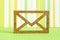 Wooden envelope icon on green striped background